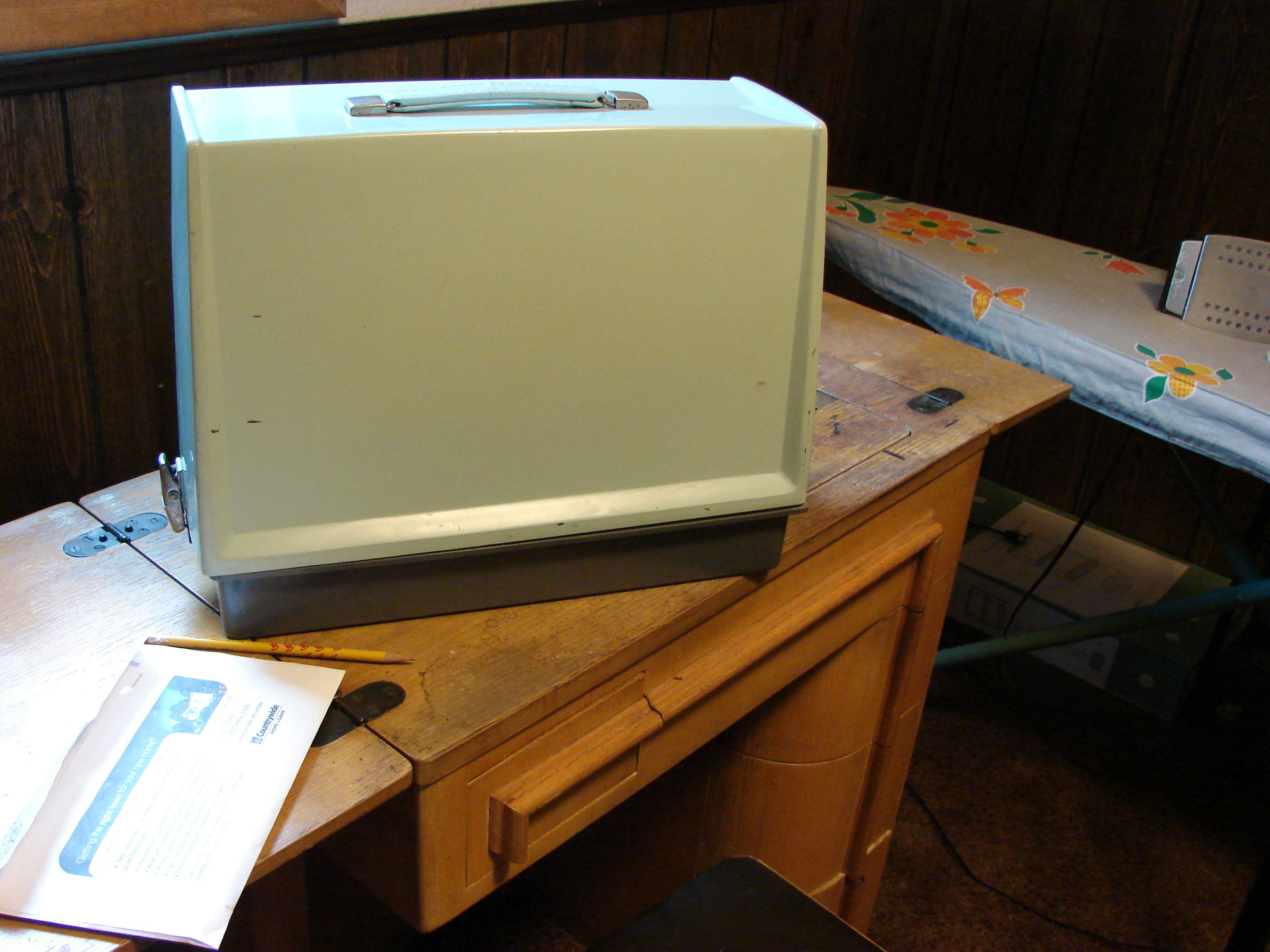 My sewing machine from college on top of Mom's old sewing machine and cabinet.