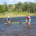 Now we're practicing our safety demonstration.  Pretend the oar is a strainer and try to get over the top of it.