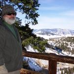 Behind Mike are hot springs and the Yellowstone River.