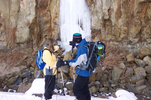 Jeremy and Kelsiann look like they're touching the frozen waterfall.  The water comes right out of the rock.