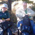 Earl and Melissa are checking the backpacks for lunch.